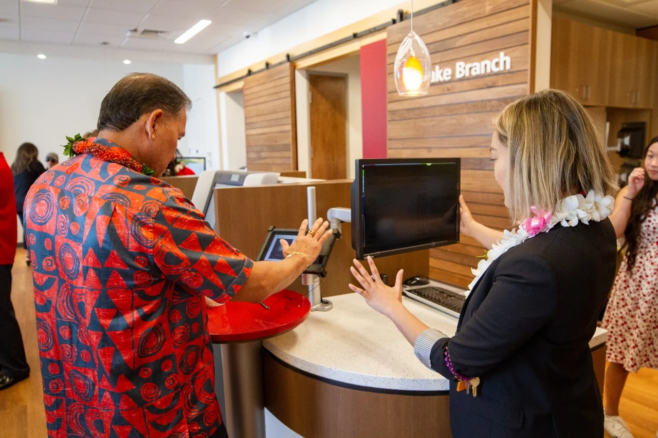 Hawaii State FCU branch with customers interacting and financial services signage.